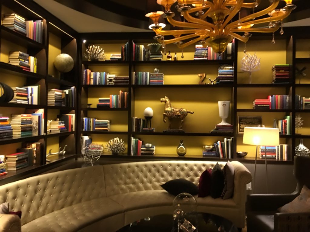 a room with a couch and bookshelves