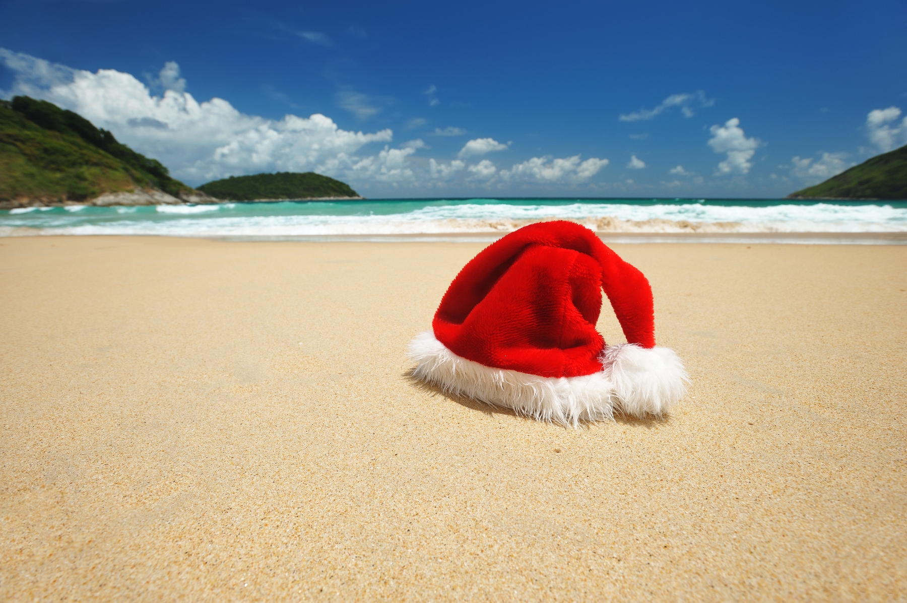 a red and white hat on a beach