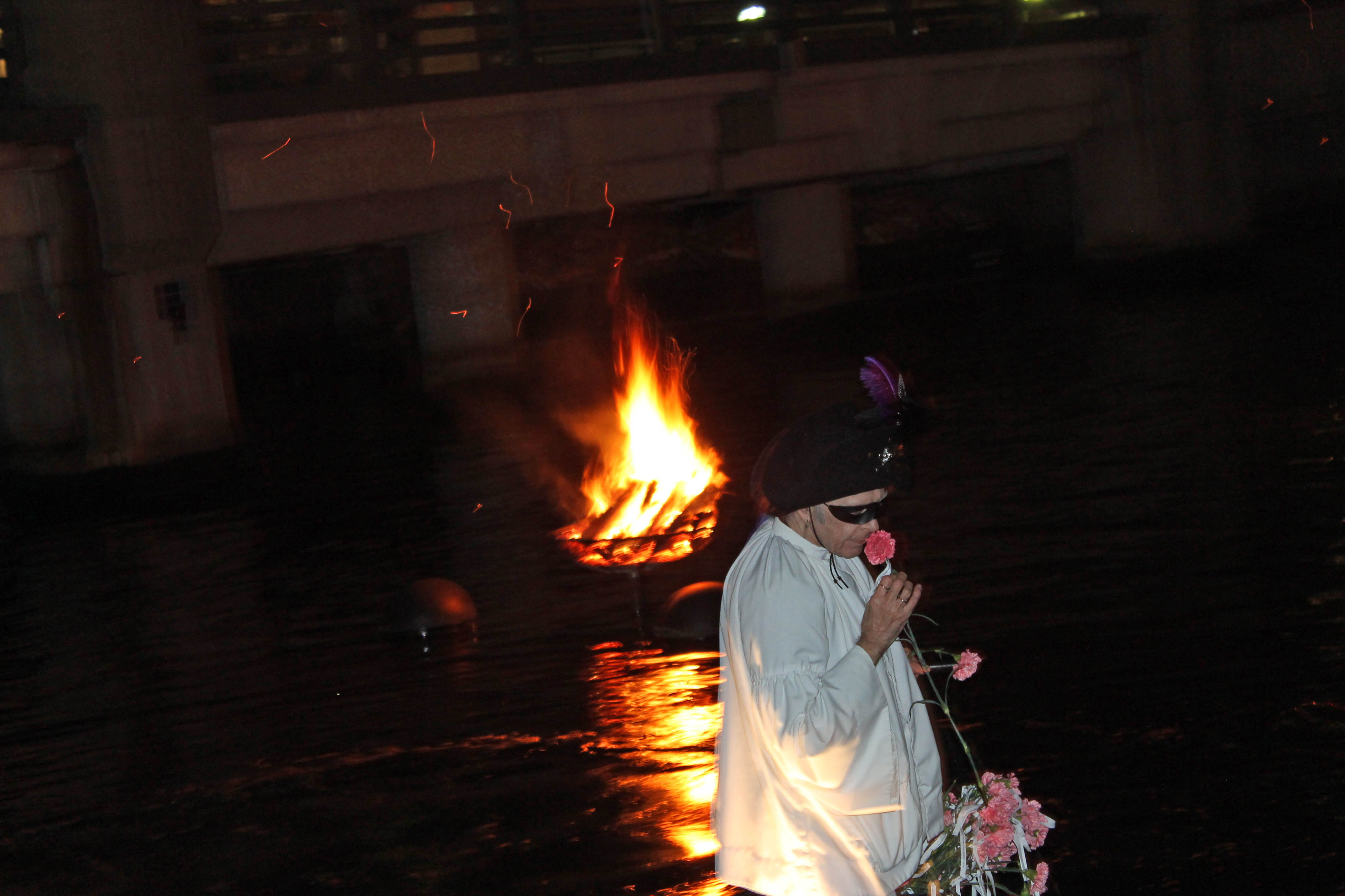 a person holding flowers in water