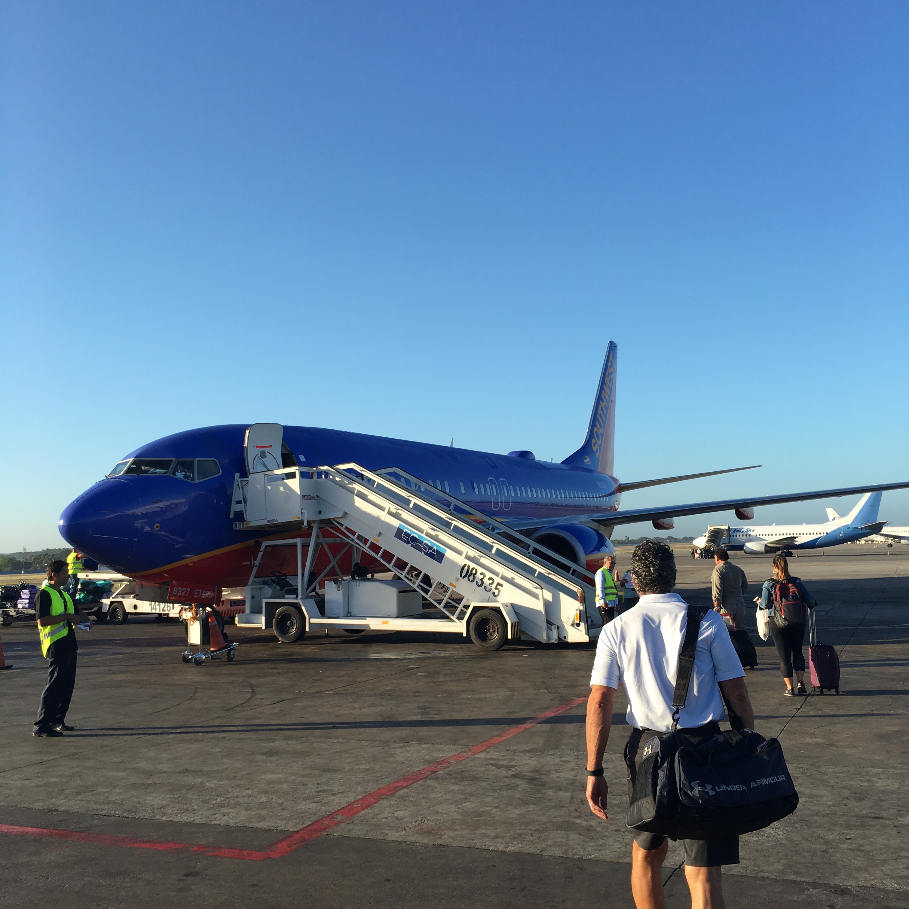 people walking towards an airplane