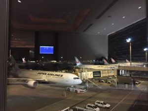 a large airport with airplanes and cars