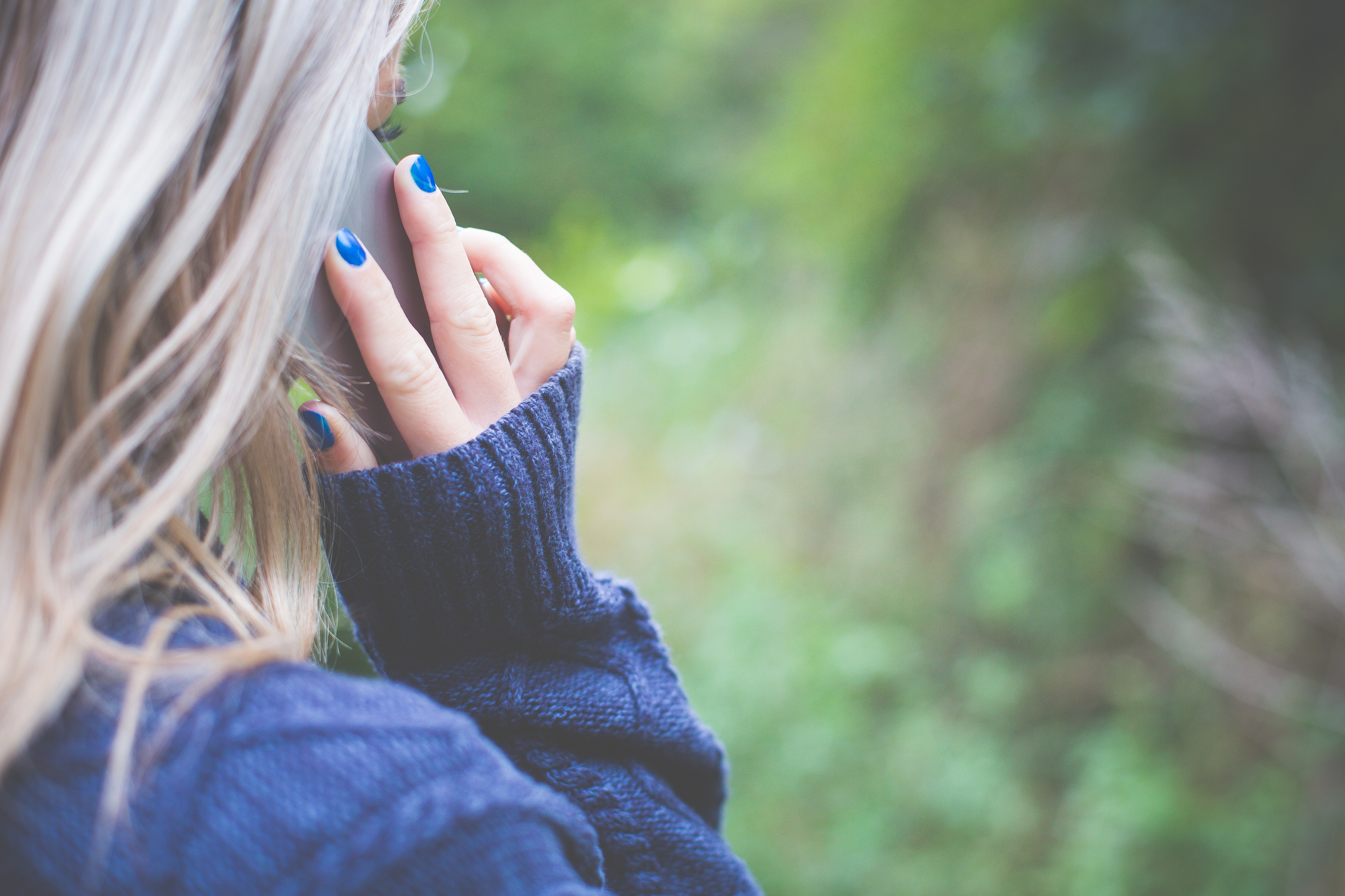 a woman holding a phone to her ear