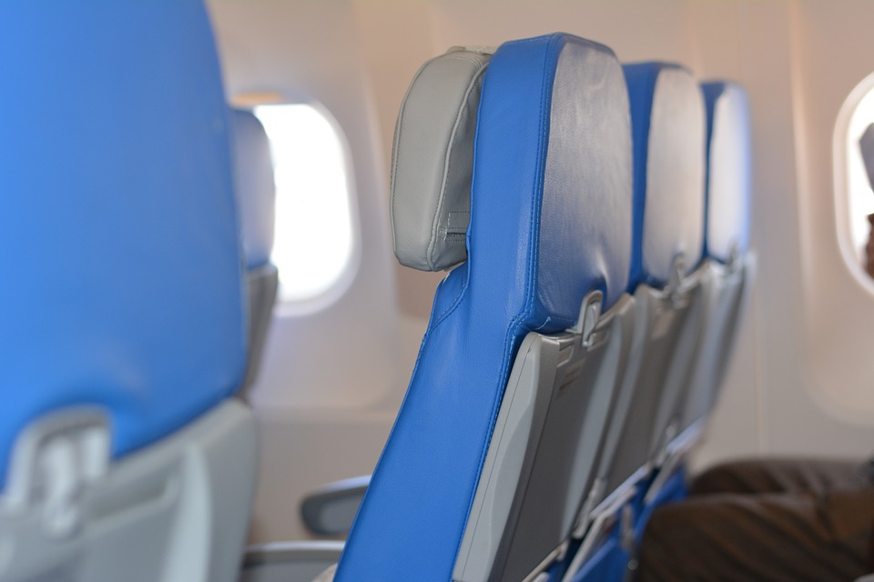 a row of blue seats in an airplane