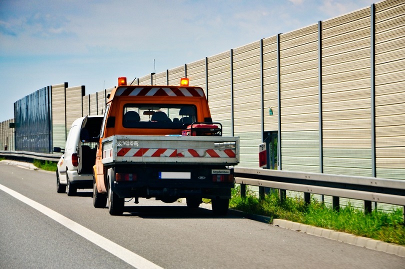 a truck with a white van on the side of the road