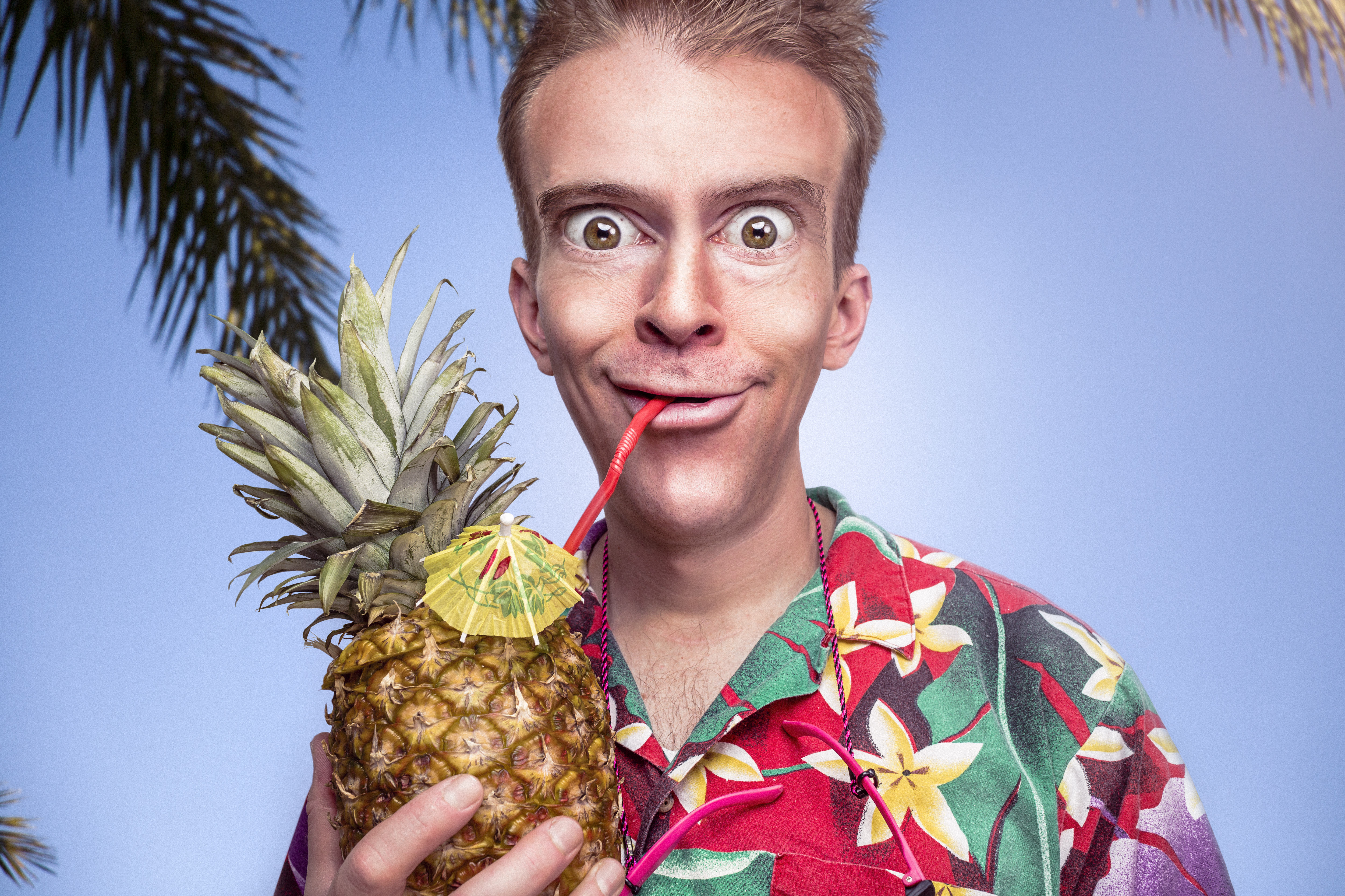 a man drinking from a pineapple