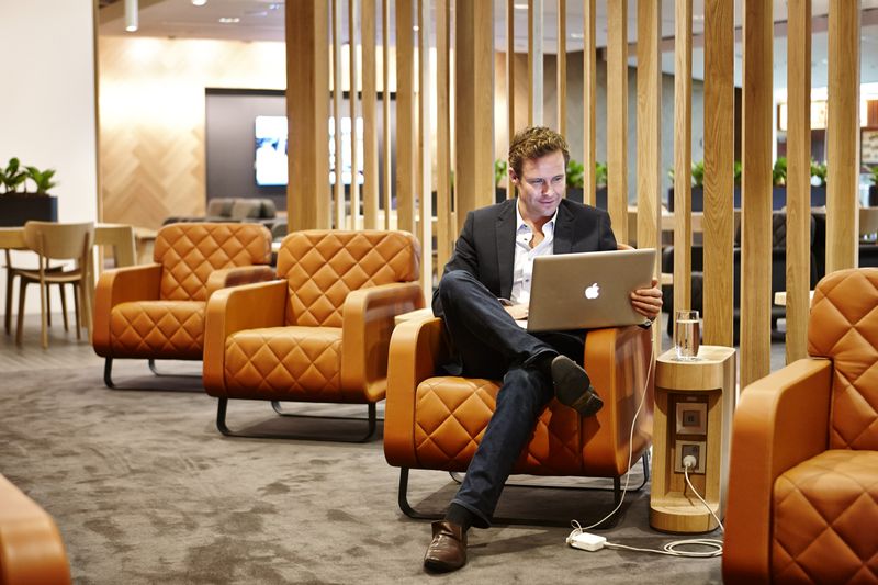 a man sitting in a chair with a laptop