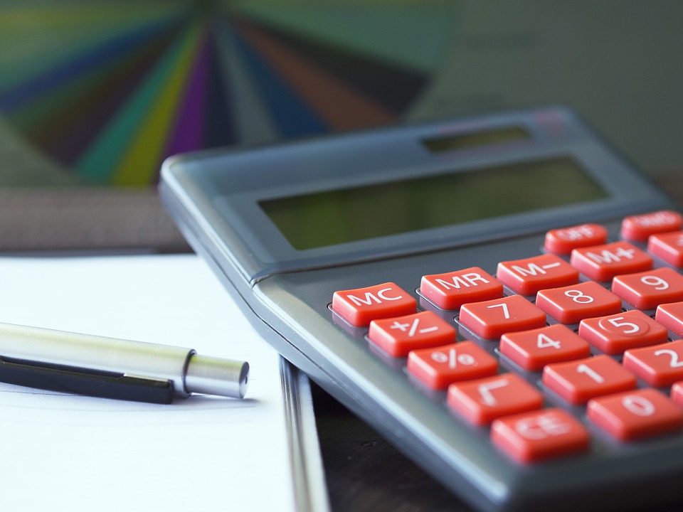 a calculator and pen on a table