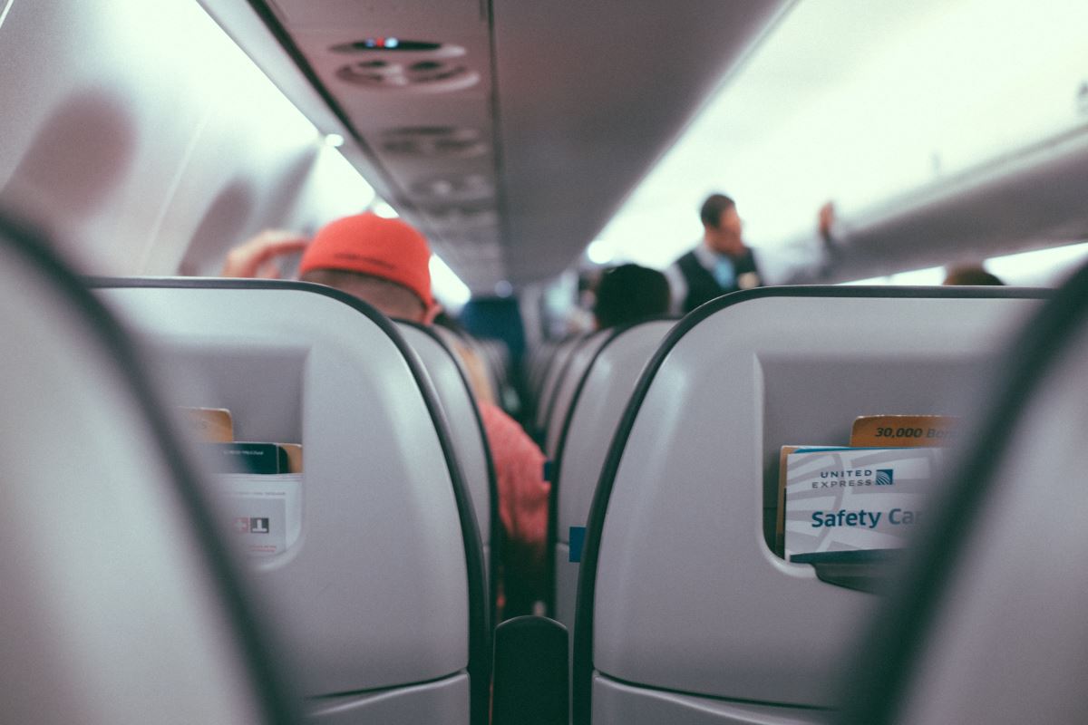 a seat on an airplane with people in the background