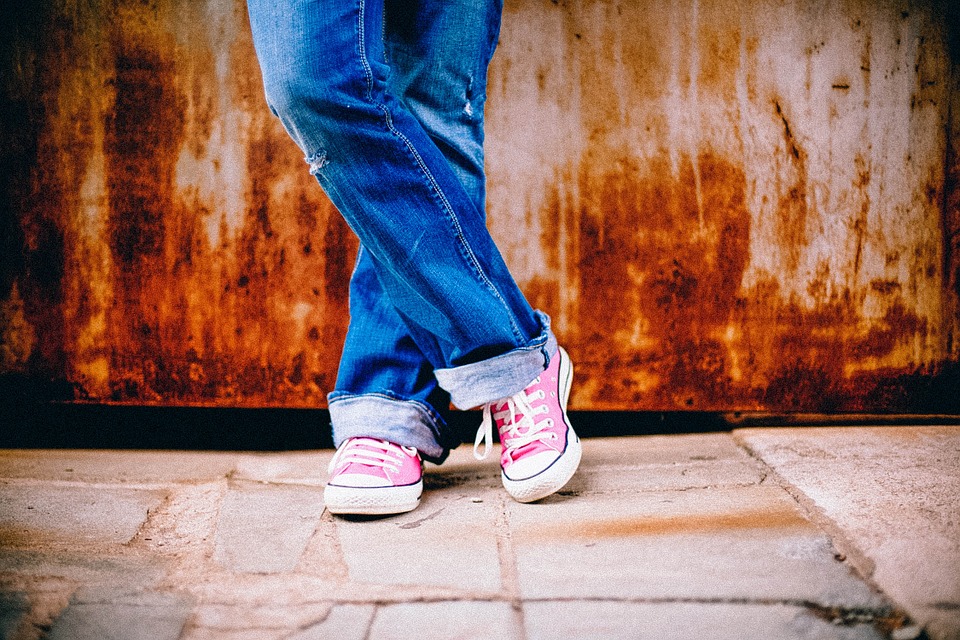 a person wearing jeans and pink shoes