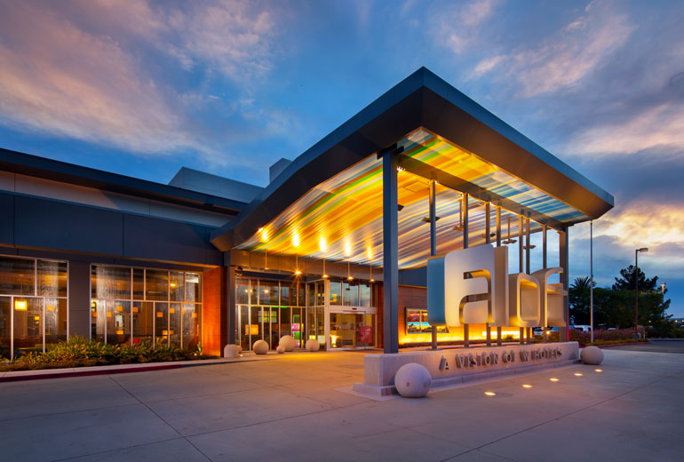 a building with a sign and a large glass entrance