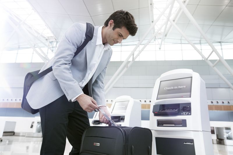 a man looking at a piece of luggage