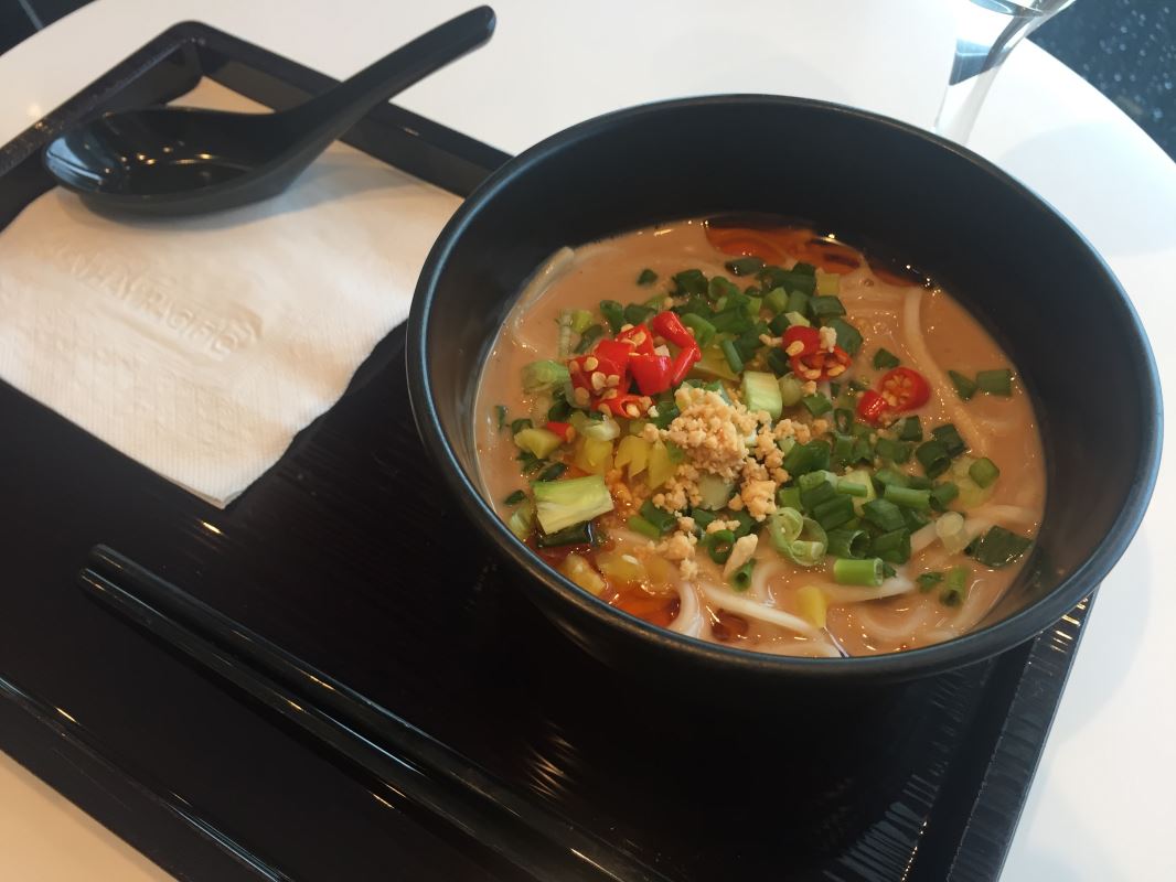 a bowl of soup with vegetables and a spoon