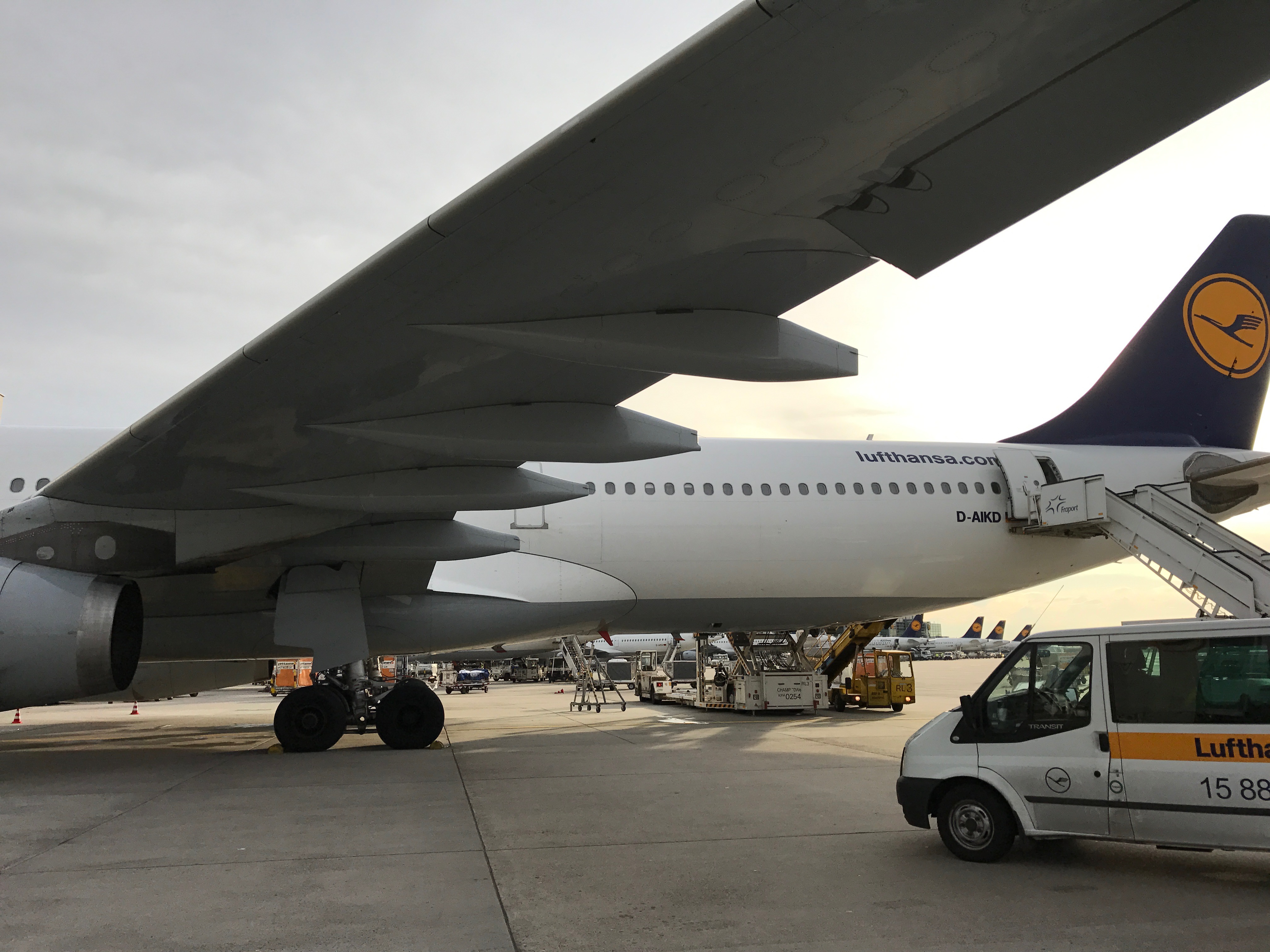 a white airplane and a van