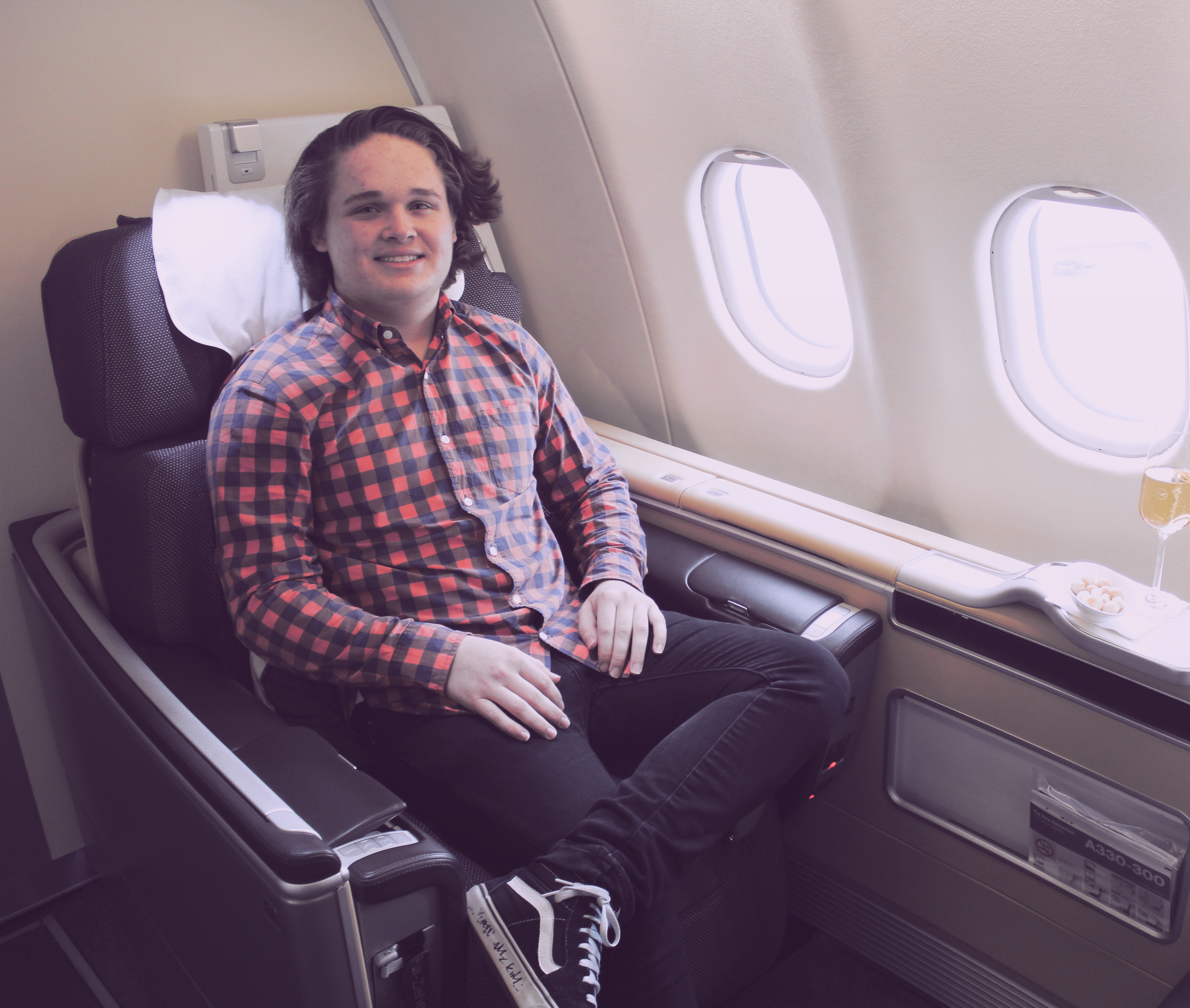 a man sitting in a chair on an airplane