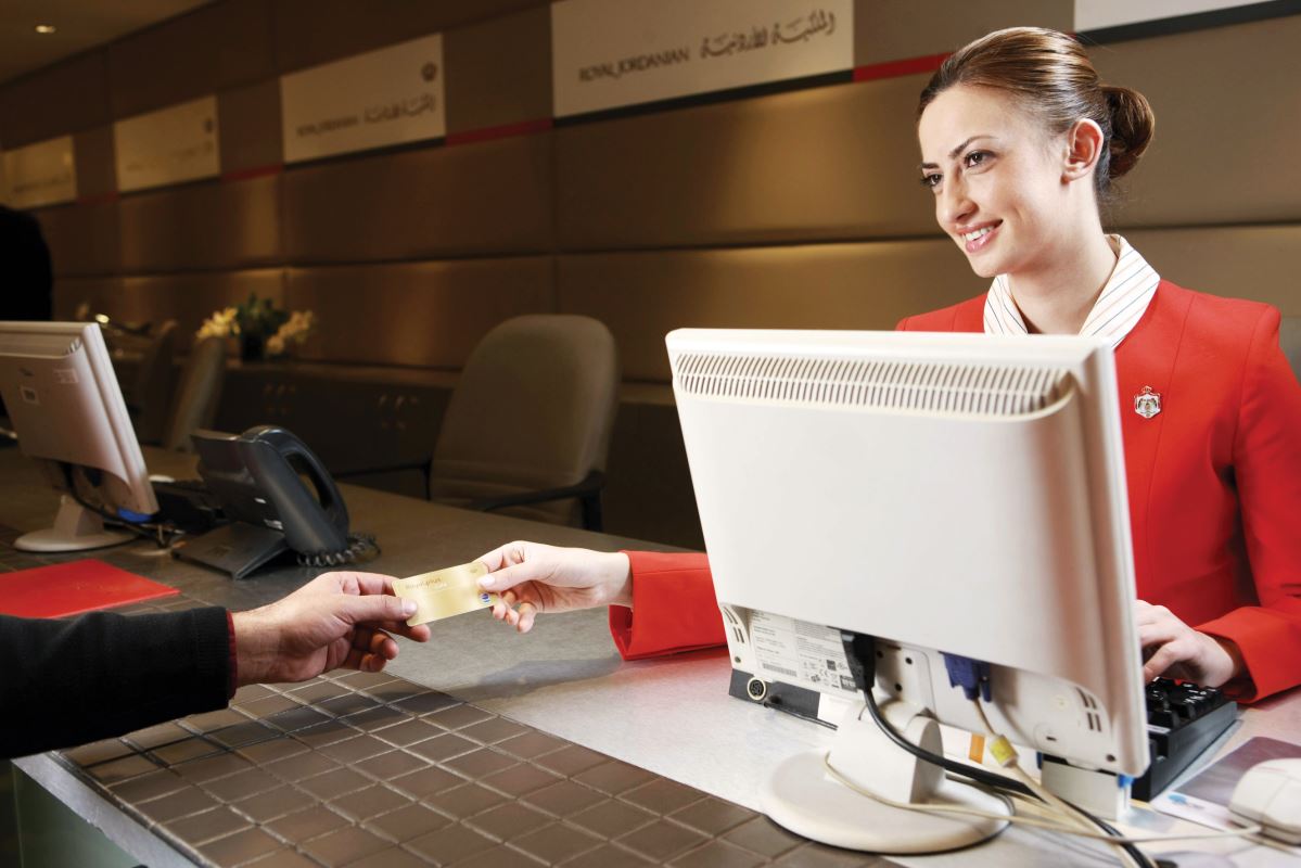 a woman handing a card to a man