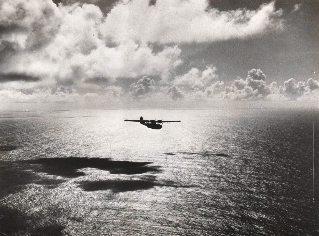 a plane flying over the water