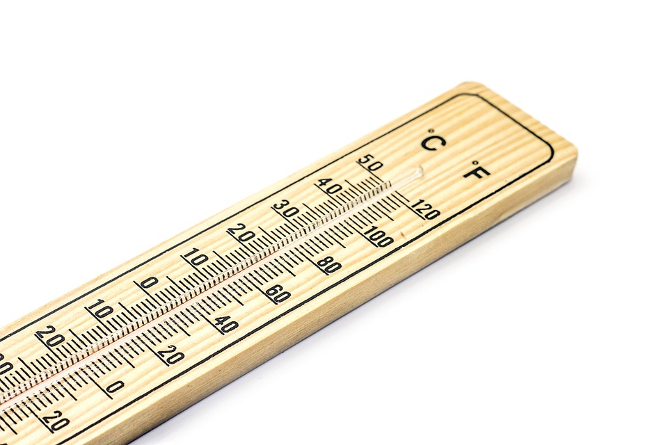 a wooden thermometer with a temperature