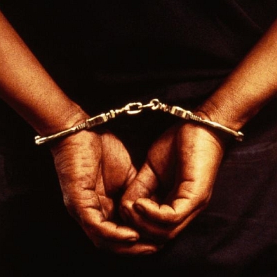 close-up of hands in handcuffs