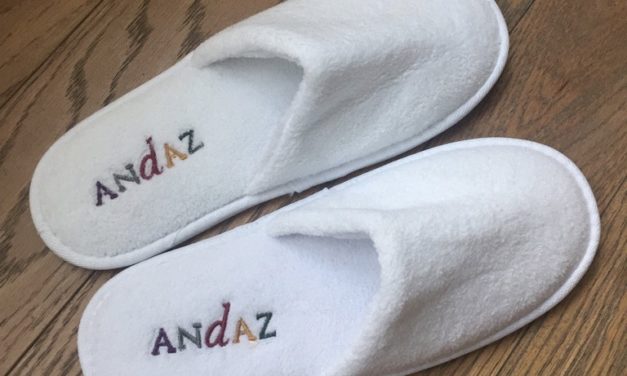 a pair of white slippers with text on them