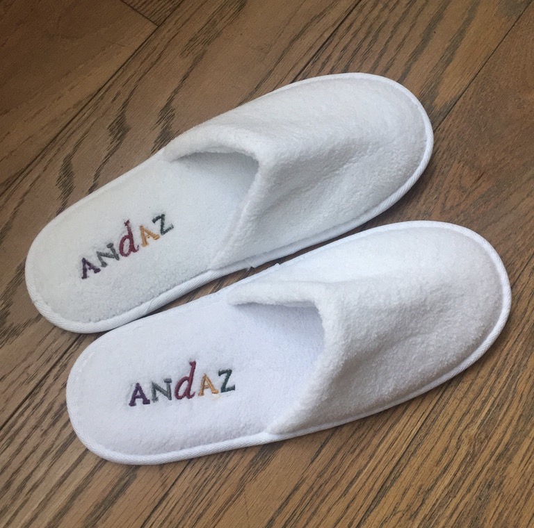 a pair of white slippers with text on them