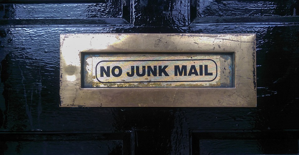 a metal mail slot on a door