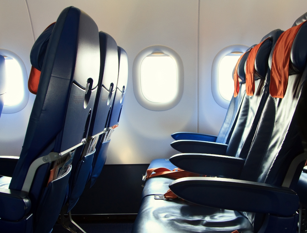 seats in an airplane with windows