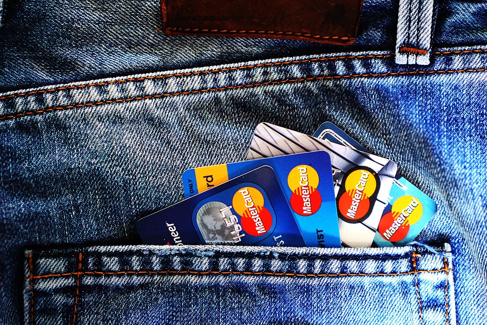 a group of credit cards in a pocket of jeans