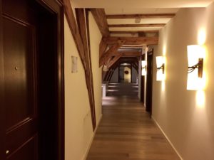 a hallway with wooden beams and a door