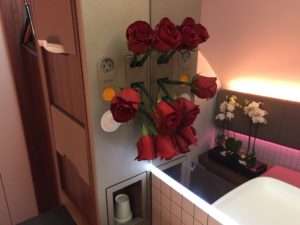 a bunch of red roses on a refrigerator