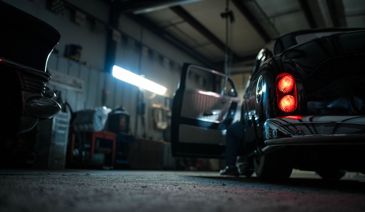 a car with red lights in a garage