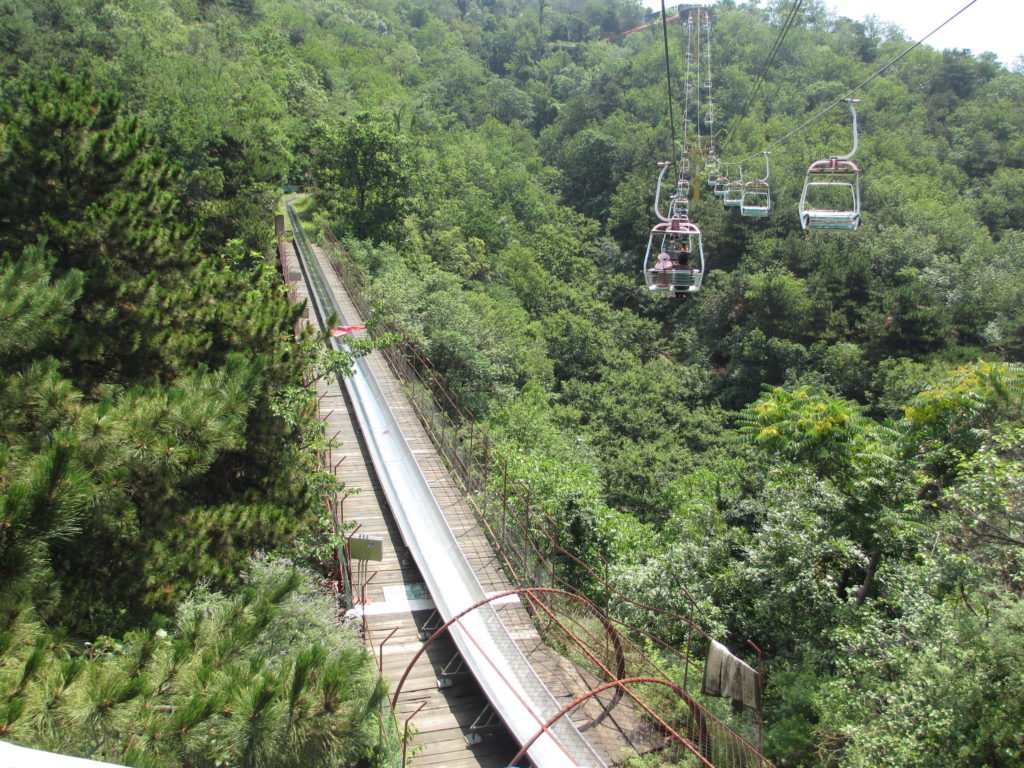 a cable car going down a hill with trees