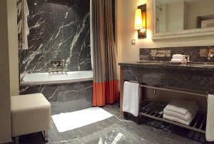 a bathroom with marble walls and a sink