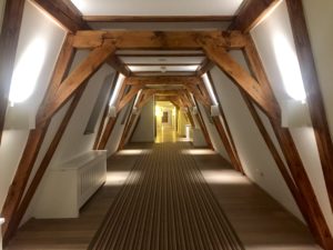 a hallway with wooden beams and a carpet