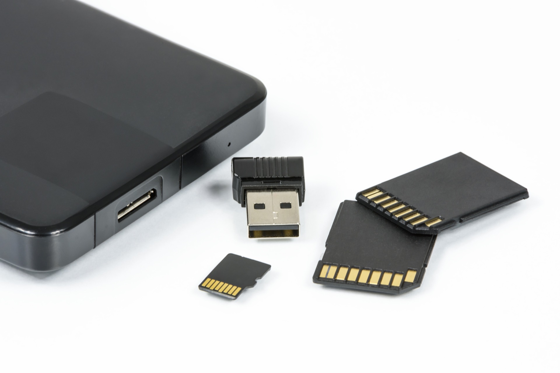 a black device with several memory cards next to it