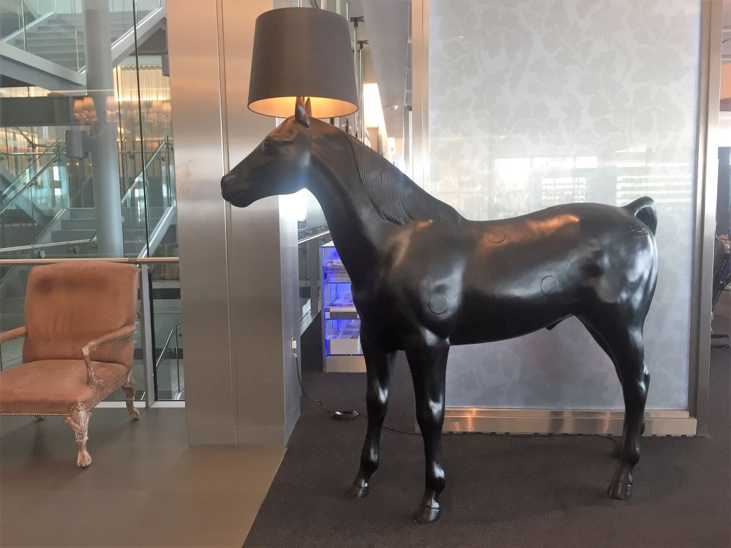 a statue of a horse with a lamp