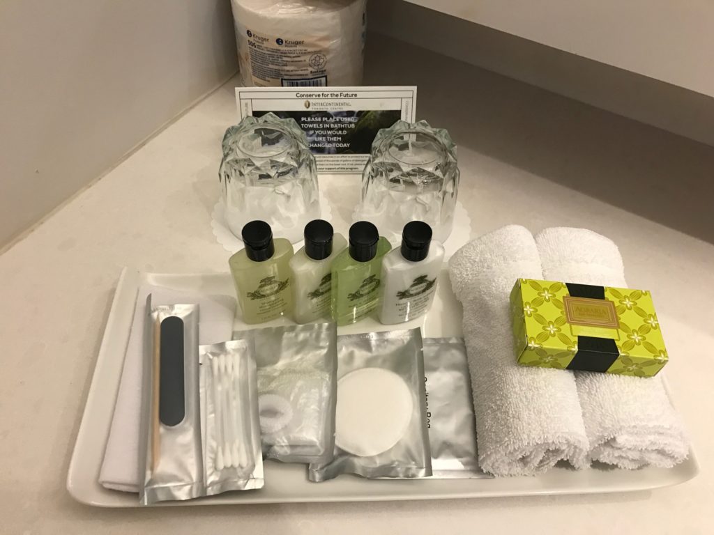 a tray with a group of toiletries and towels