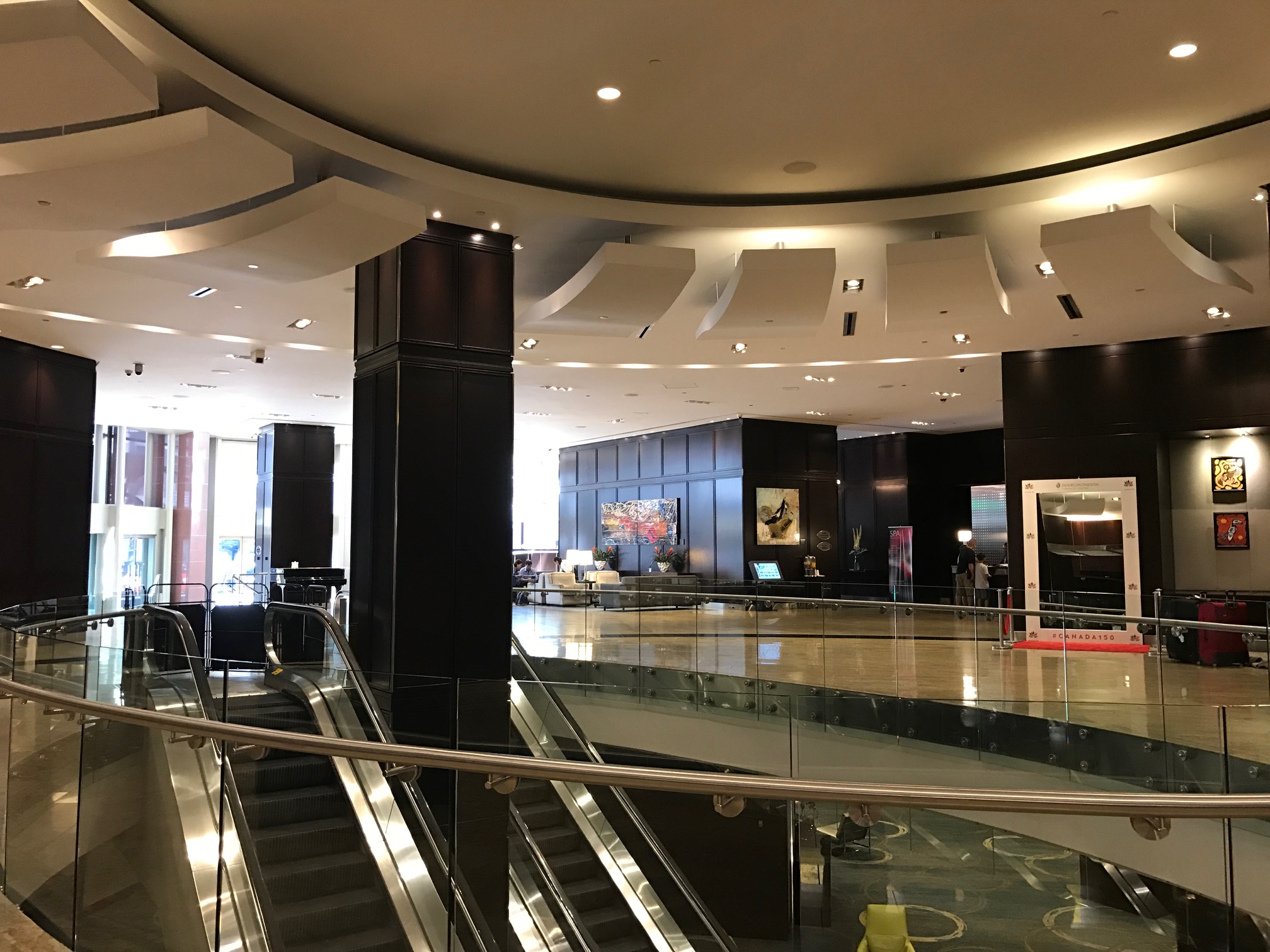 a large hall with escalators and a large building