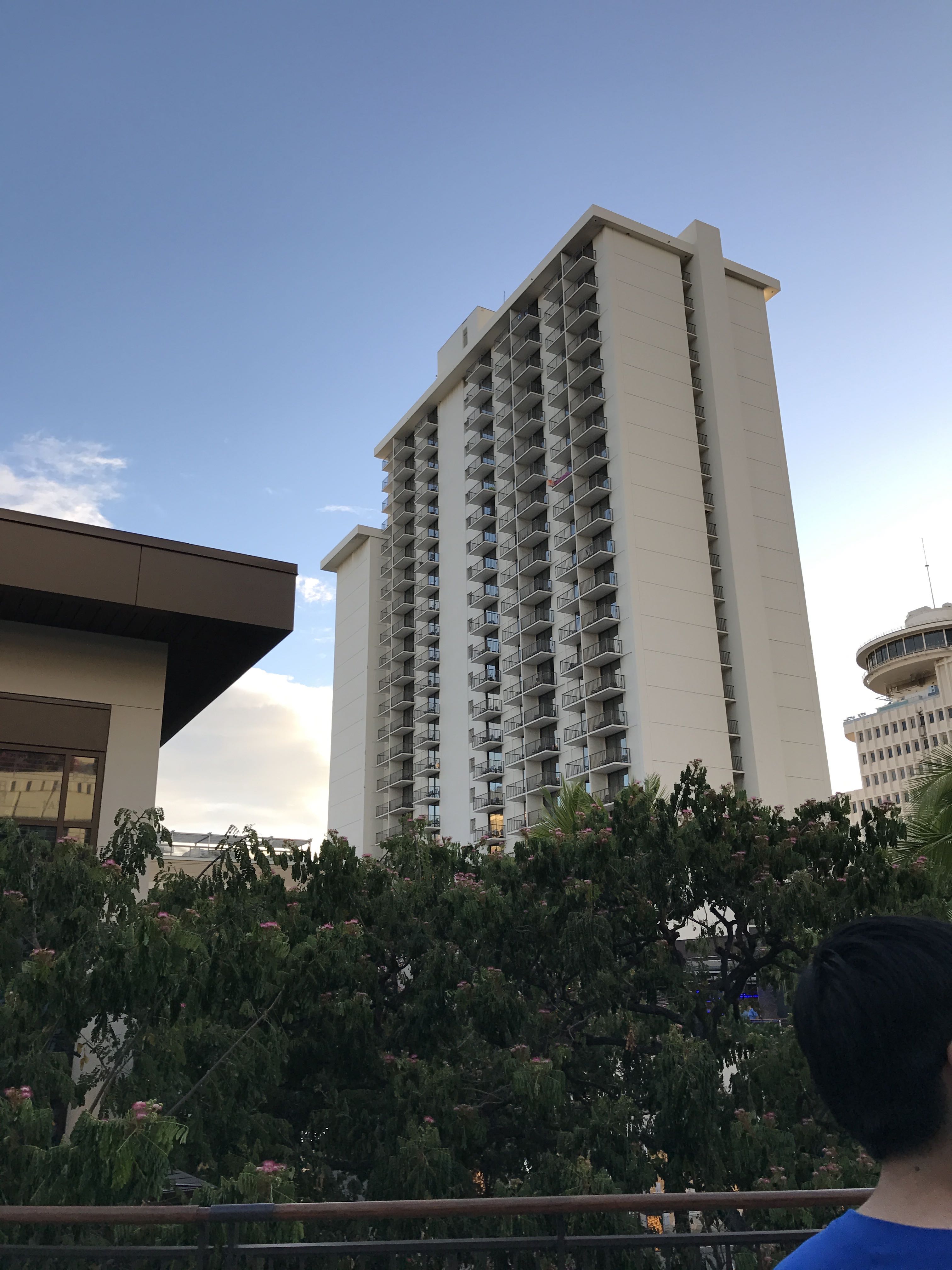 a tall building with trees in the background