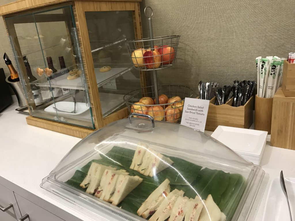 a tray of sandwiches on a leafy surface