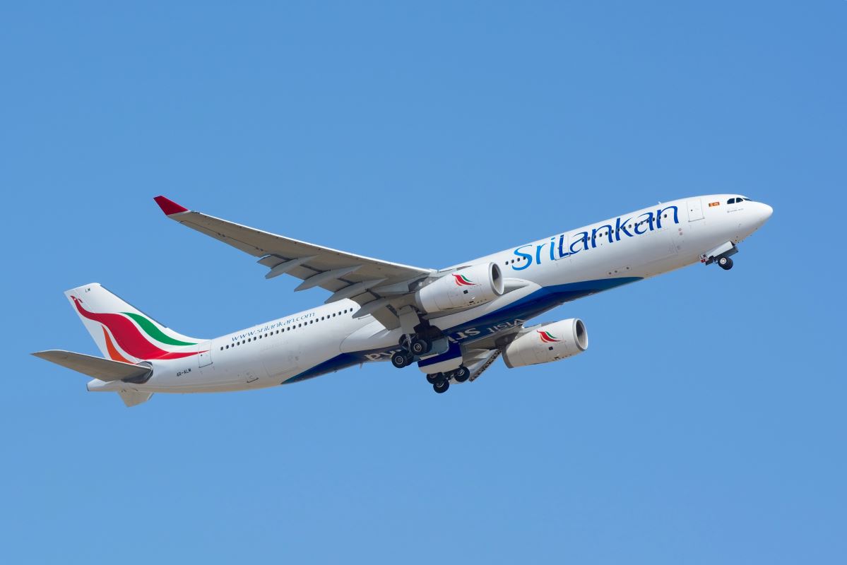 a white airplane flying in the sky