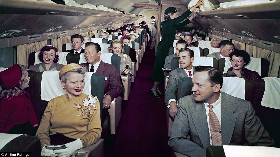 a group of people sitting in an airplane