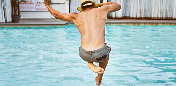 a man jumping into a pool