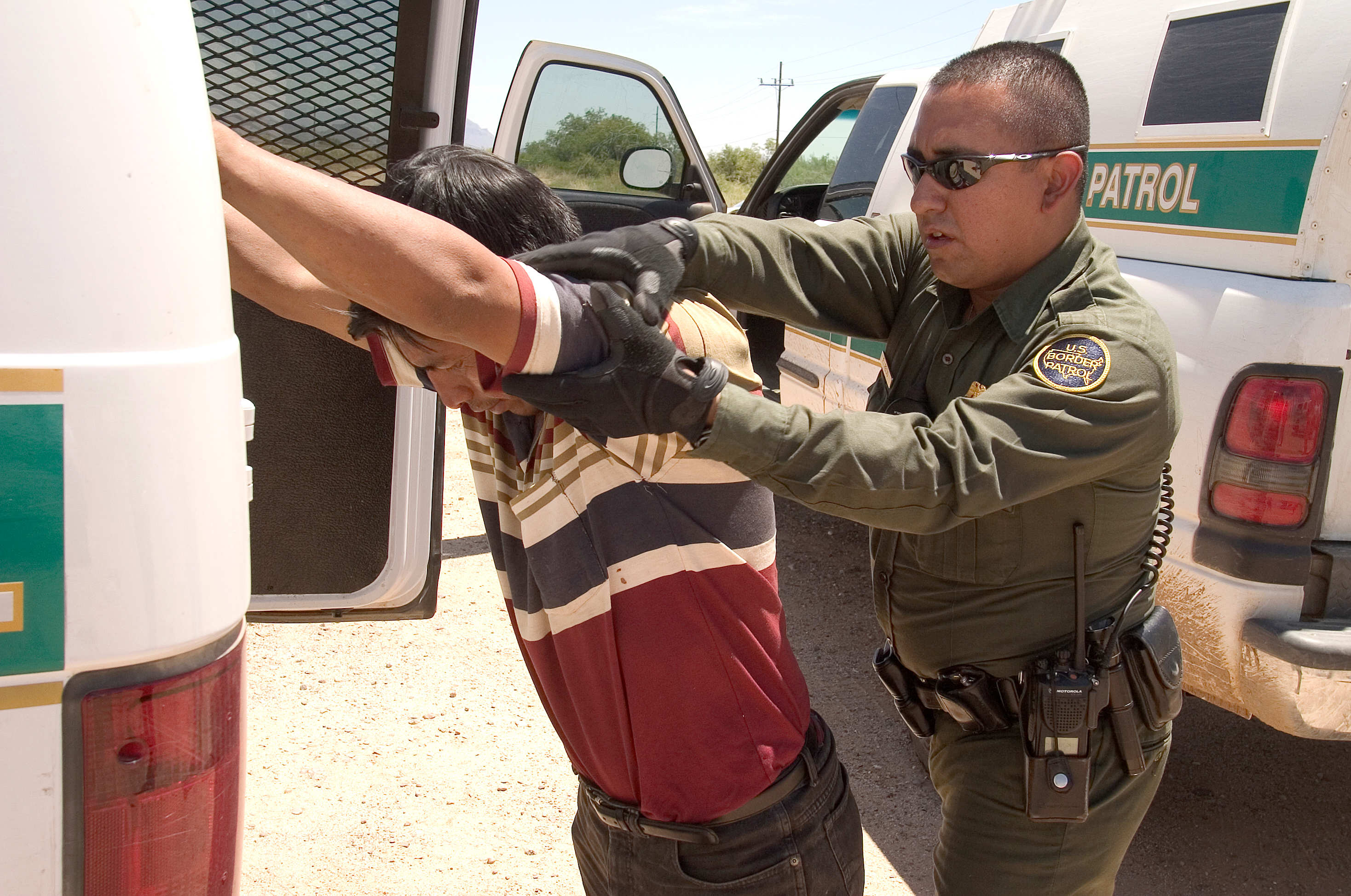 a police officer putting a hand on a man