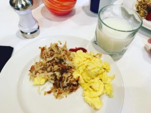 a plate of food and a glass of milk