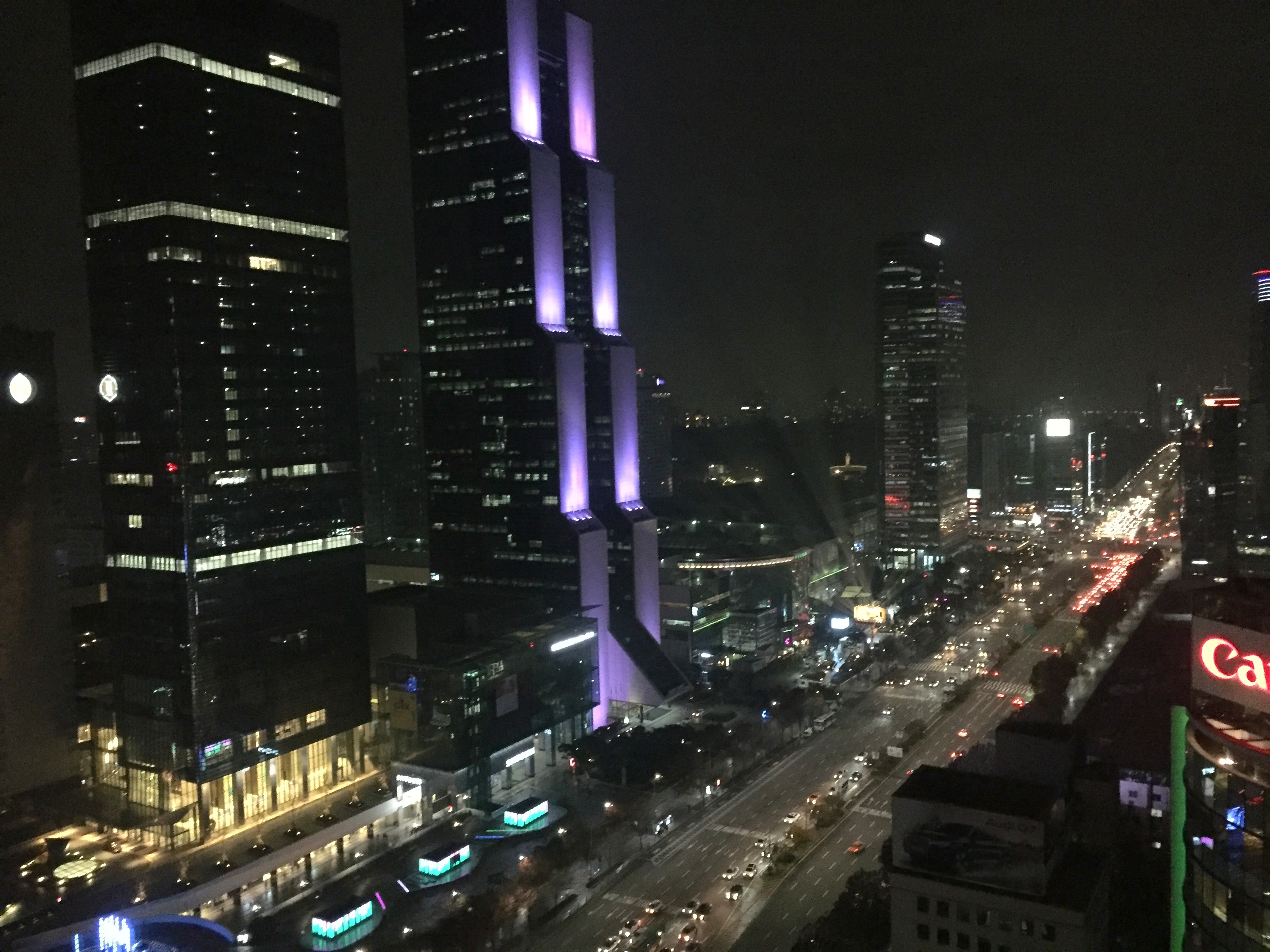 a city at night with tall buildings