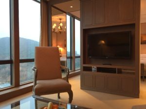 a living room with a television and a chair