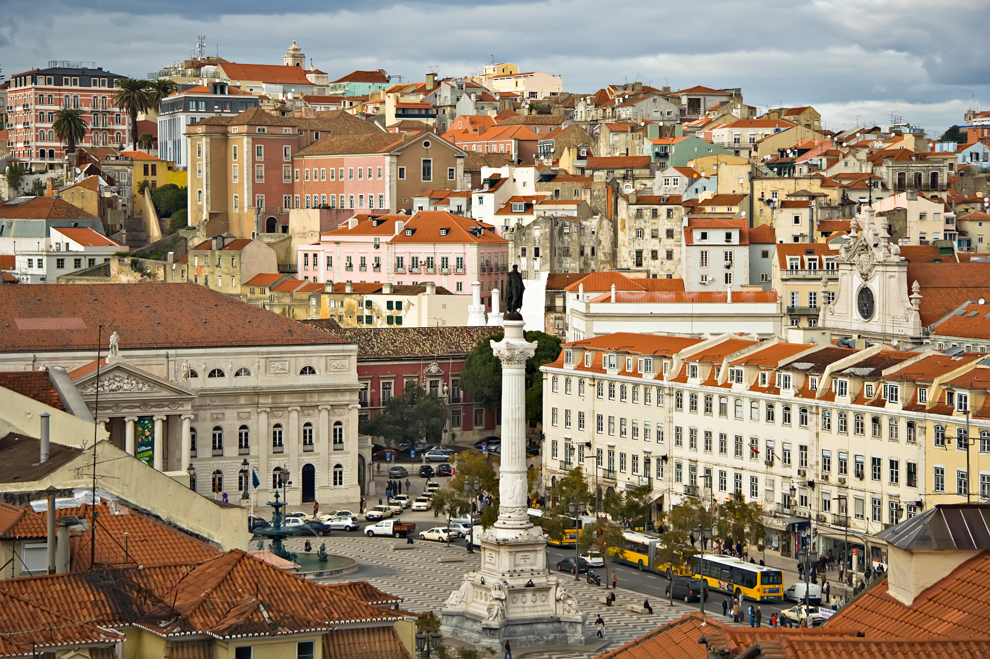 a city with a statue and buildings