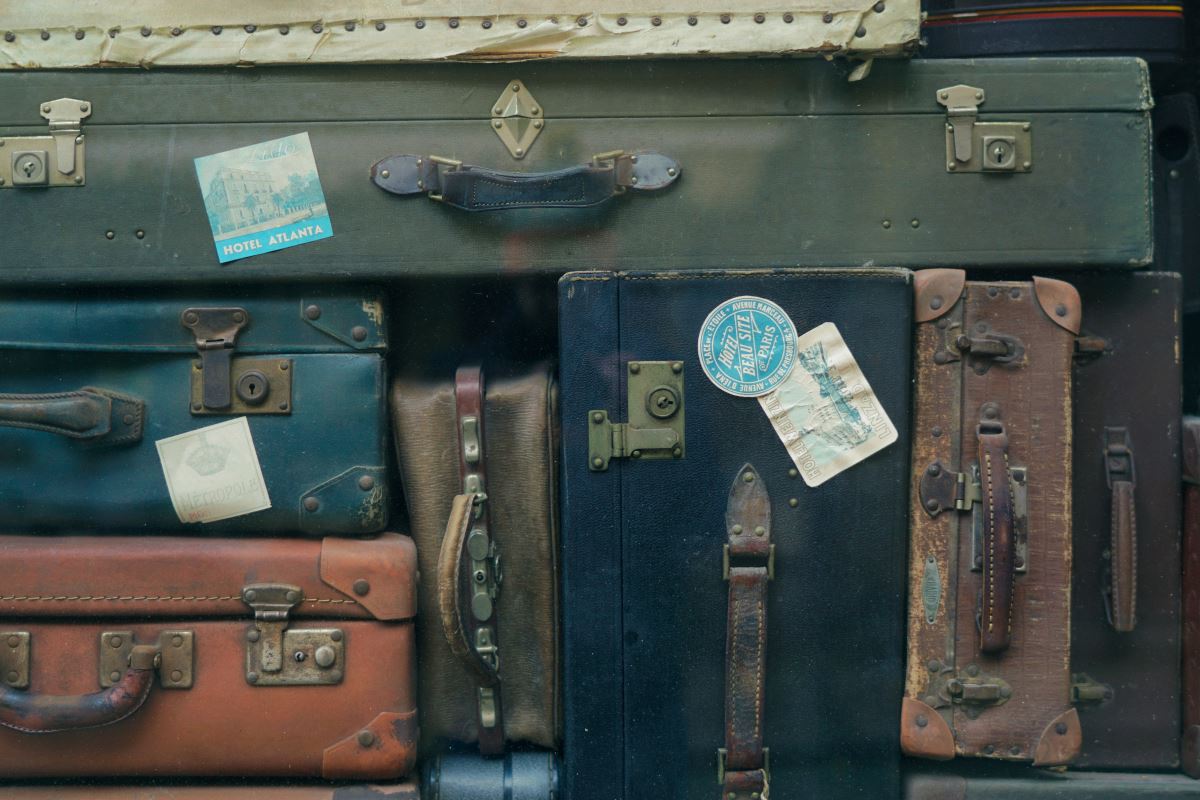 a group of suitcases with tags