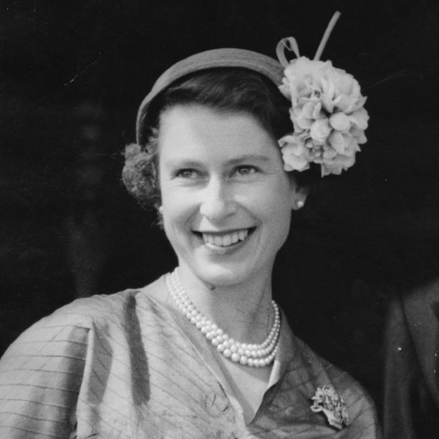 a woman smiling with a flower in her hair