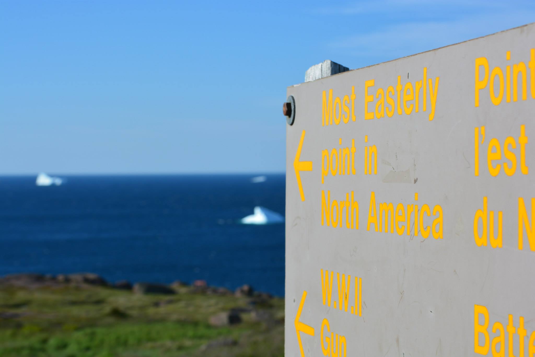 a sign with yellow writing on it